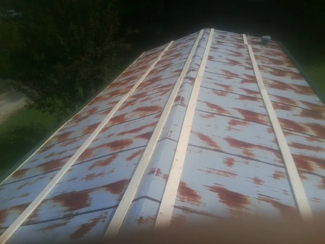 Rusted metal roof panels with new wood purlins before replacement — Storm Damage Roof Repair in Aptos by Roofing Brothers