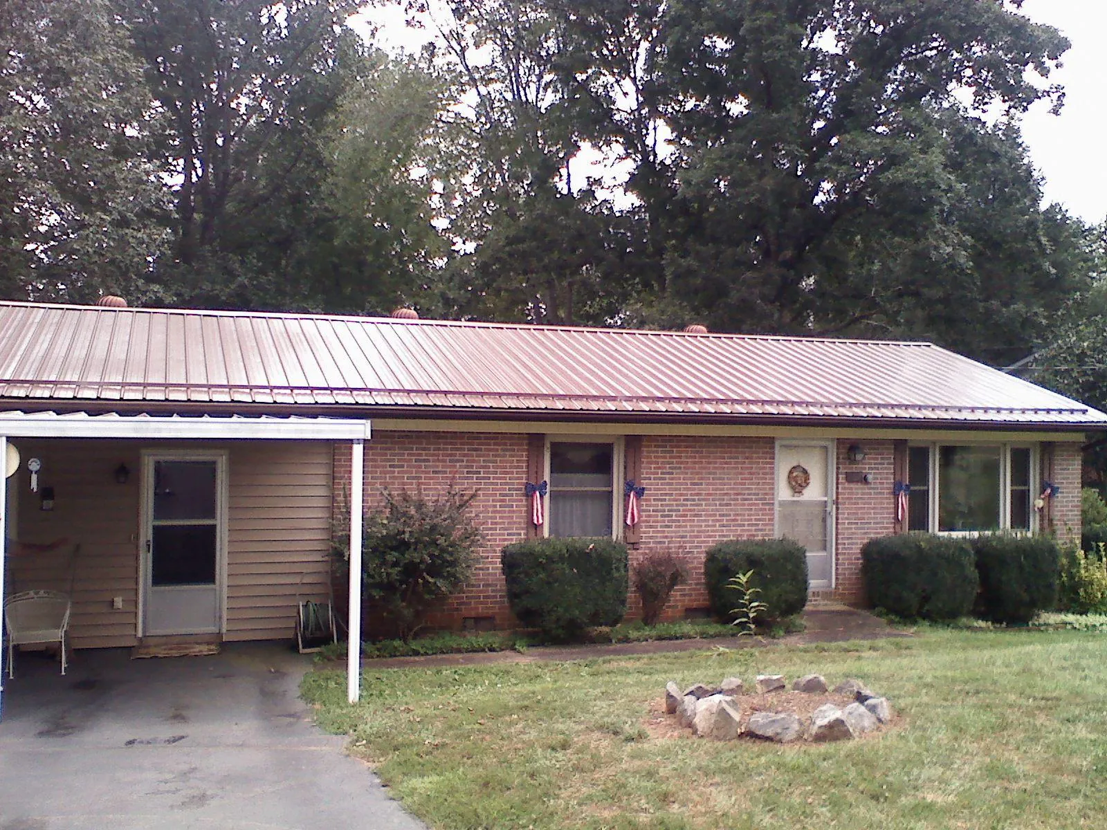 Bronze metal roof and carport on a brick ranch home — Roof Repair work by our crew in Aptos