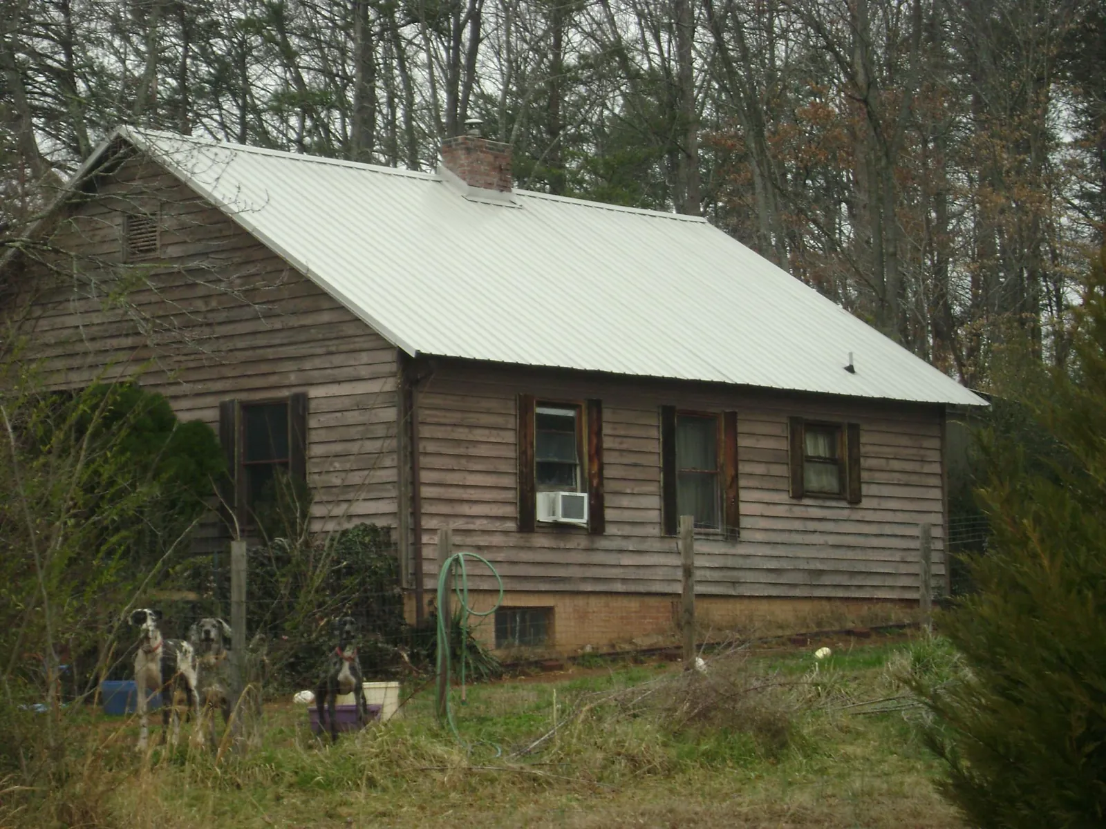 White metal roof on an old wood sided farmhouse, from a Metal Roof Installation job in Aptos